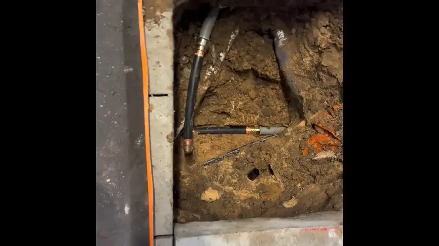 Exposed sewer pipe and repair access in soil related to Sewer Line Repair in Altadena, CA