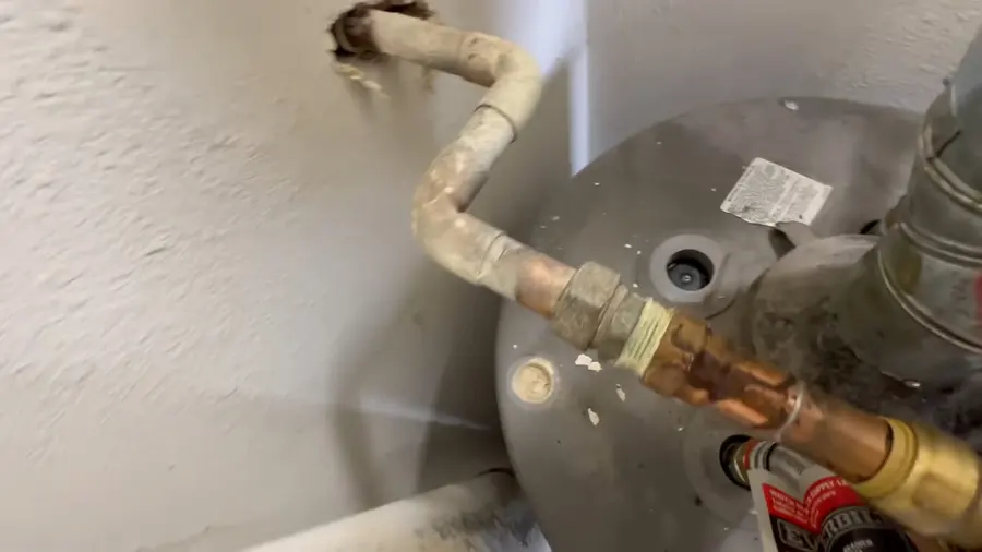 Water heater anode rod and top tank fittings during a plumbing service visit in Arcadia