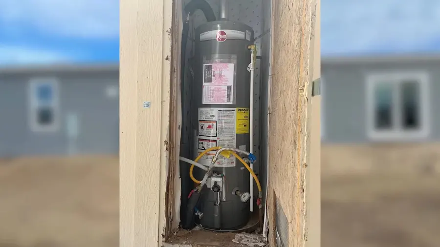 Residential water heater tank, supply lines, and service fittings during a plumbing service visit in Chapman Woods