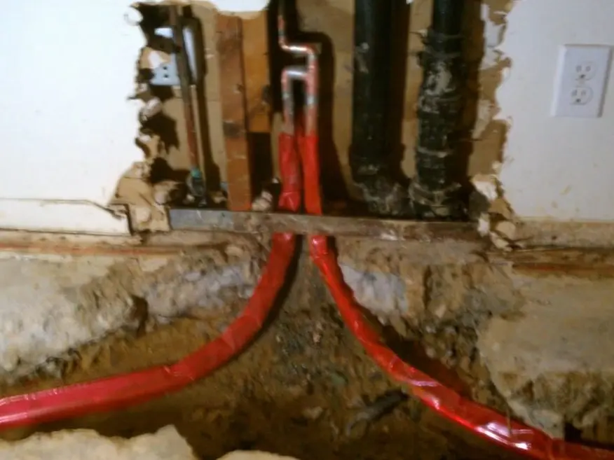 Residential water heater tank, supply lines, and service fittings during a plumbing service visit in Country Club Drive Altadena on the ccd-side-01 section