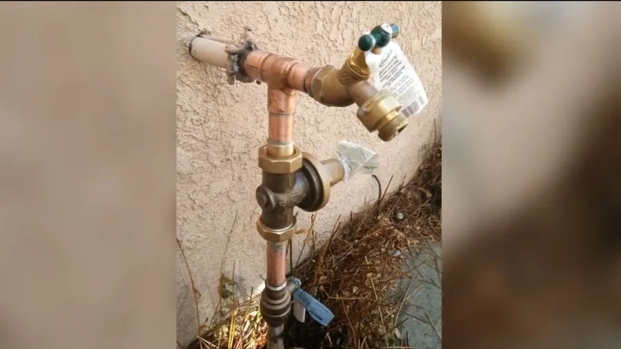 Residential water heater tank, supply lines, and service fittings during a plumbing service visit in Eagle Rock